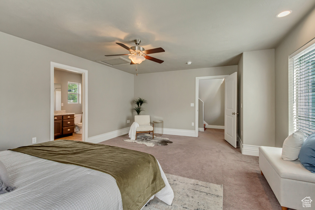 Bedroom featuring light colored carpet, ceiling fan, baseboards, and multiple windows