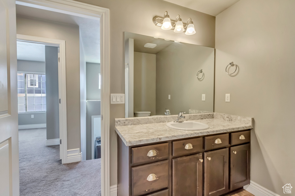 Bathroom featuring vanity and baseboards