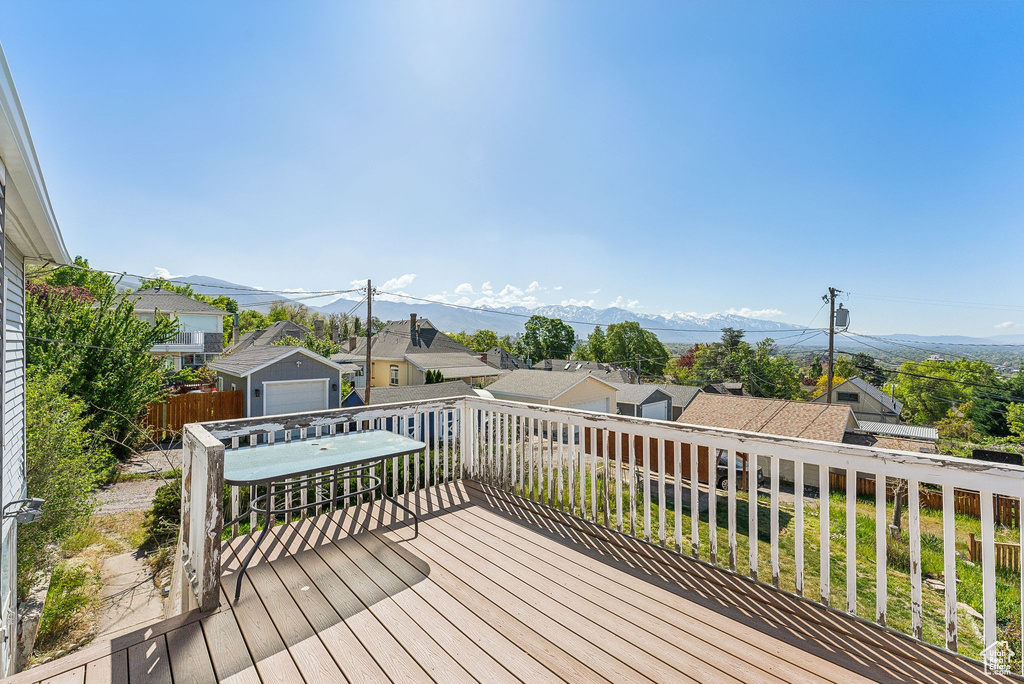 Deck with a residential view and a mountain view