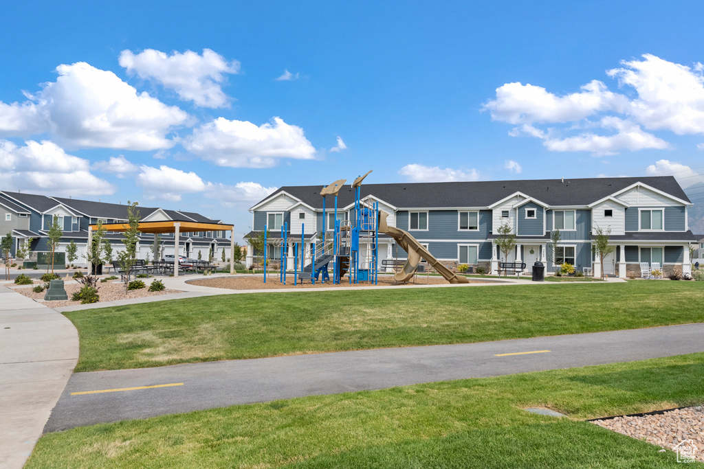 Exterior space with a residential view and a lawn