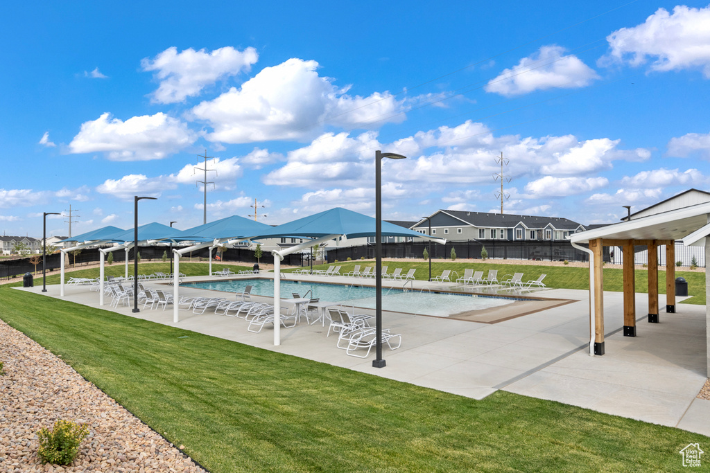 Community pool with fence, a patio, a gazebo, and a yard