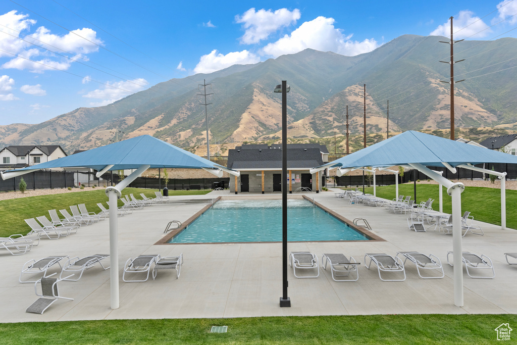 Community pool featuring a patio, a mountain view, fence, and a gazebo