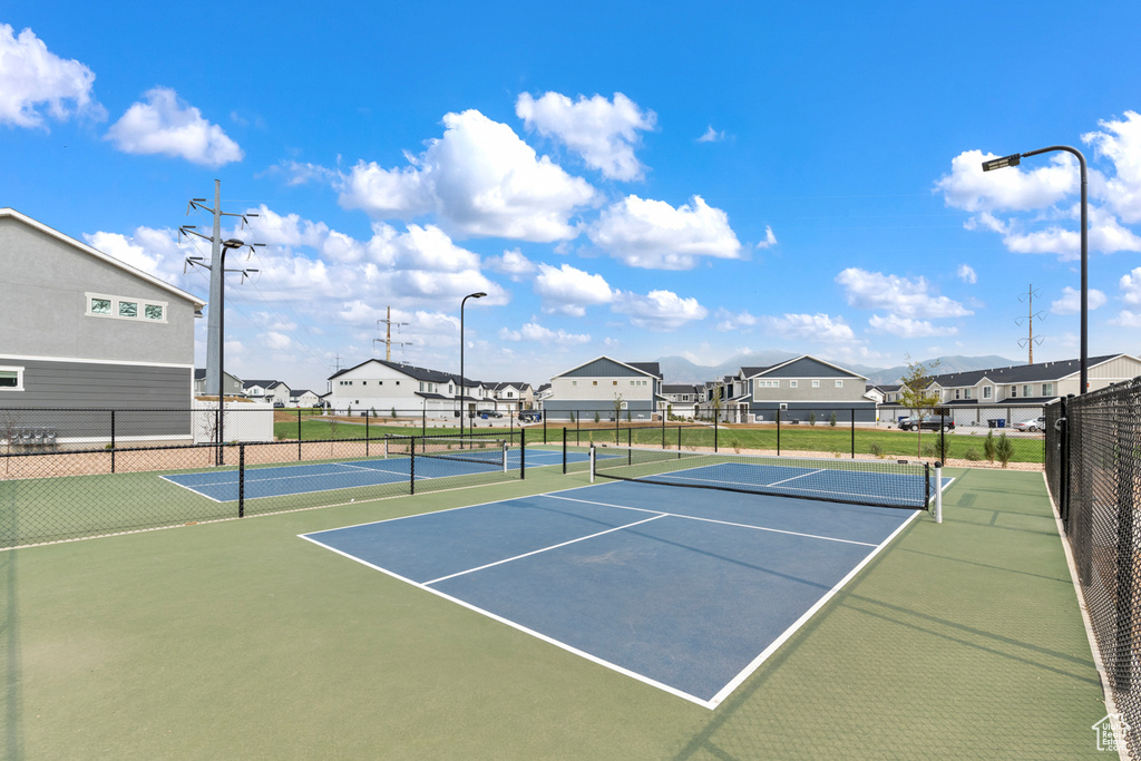 View of sport court with fence and a residential view