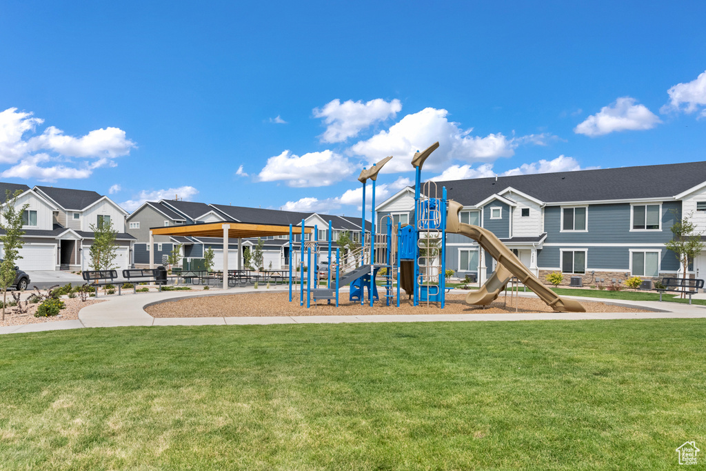 Community play area featuring a residential view and a yard