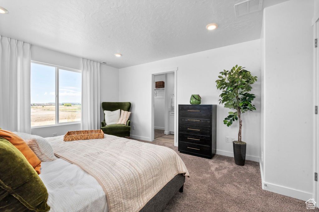 Bedroom featuring visible vents, baseboards, recessed lighting, a textured ceiling, and carpet flooring