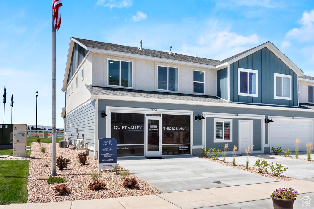 Modern farmhouse style home featuring board and batten siding, driveway, and a garage