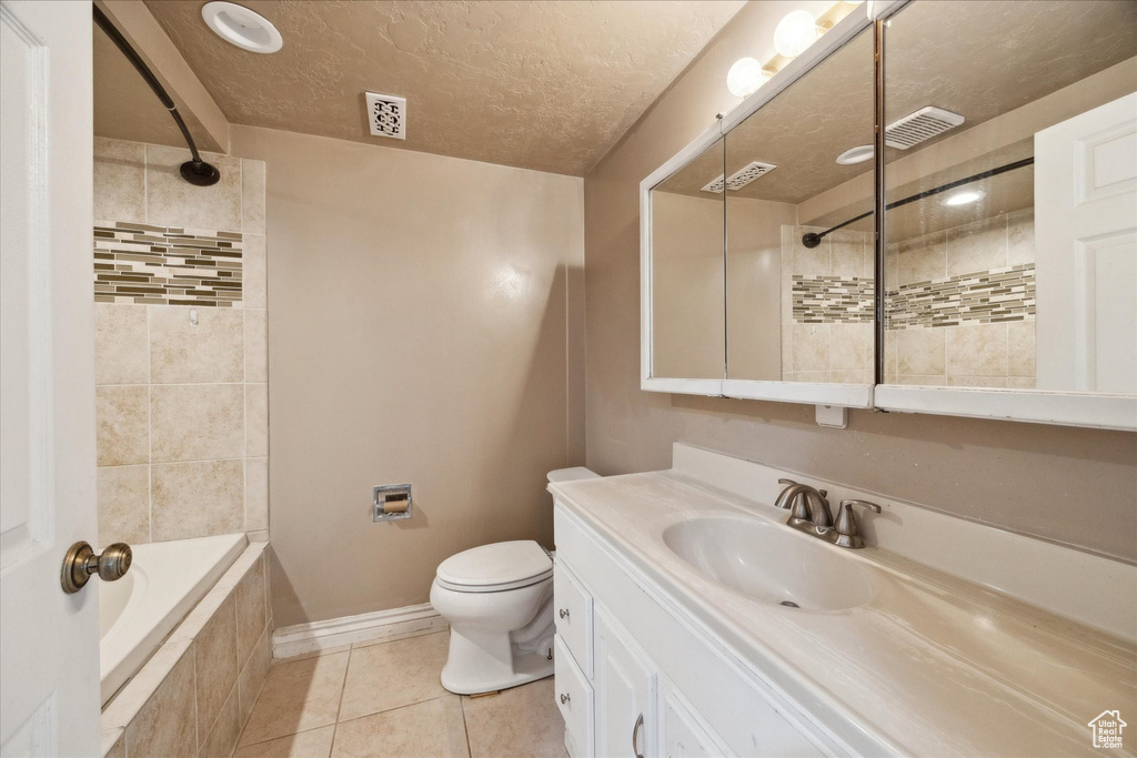 Bathroom with vanity, toilet, tile patterned floors, baseboards, and visible vents
