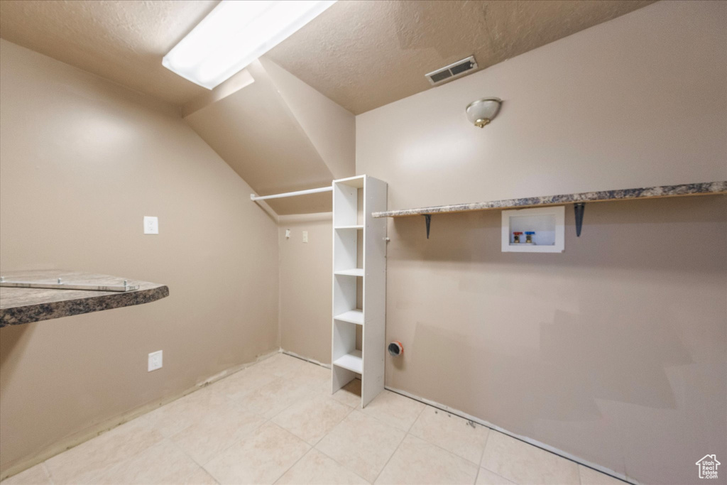 Spacious closet featuring visible vents and light tile patterned floors