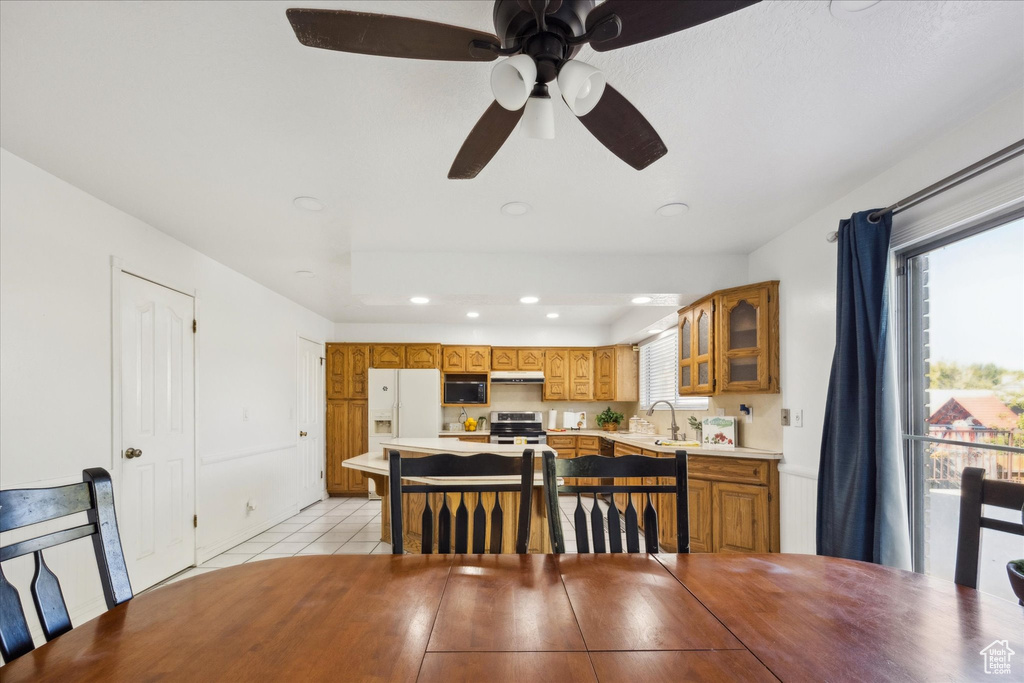 Dining room featuring a ceiling fan, recessed lighting, plenty of natural light, and light tile patterned flooring