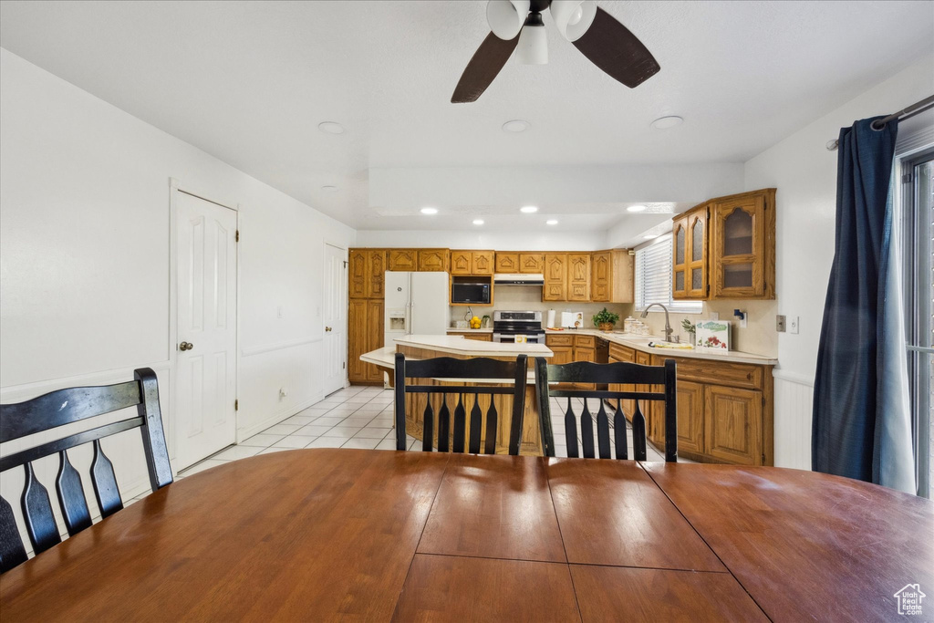 Dining room featuring recessed lighting, ceiling fan, and light tile patterned floors