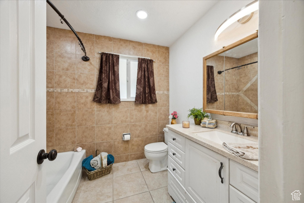 Full bath with tile patterned flooring, vanity, a shower, toilet, and a bathing tub