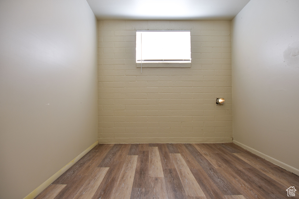 Unfurnished room featuring baseboards and wood finished floors