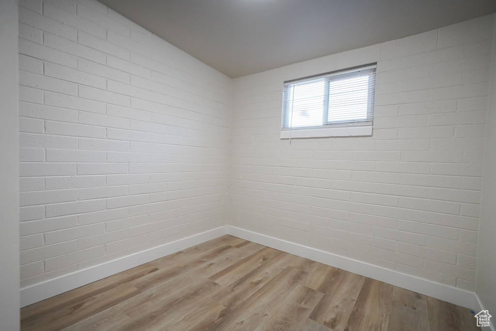 Empty room with baseboards and light wood-style flooring
