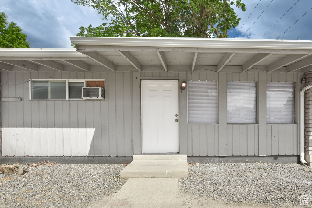 Doorway to property with a wall mounted air conditioner