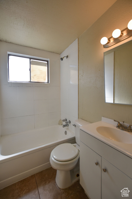 Bathroom featuring vanity, toilet, bathing tub / shower combination, and a healthy amount of sunlight