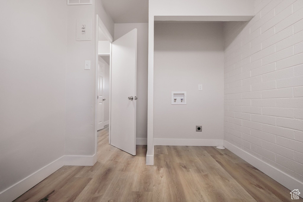 Washroom featuring laundry area, hookup for a washing machine, hookup for an electric dryer, and light wood-type flooring