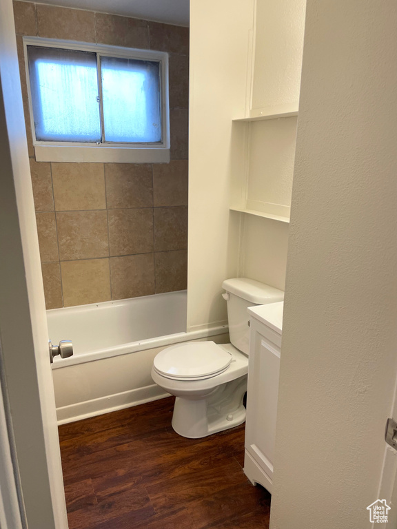 Bathroom featuring vanity, shower / bathing tub combination, wood finished floors, and toilet