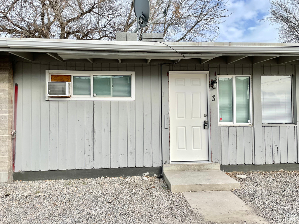 Entrance to property with a wall mounted AC