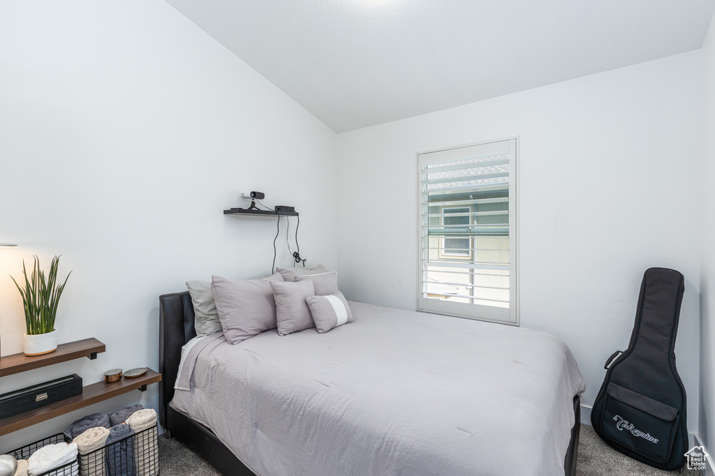 Bedroom with carpet and vaulted ceiling
