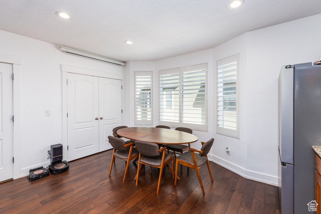 Dining space featuring recessed lighting, dark wood-style floors, and baseboards