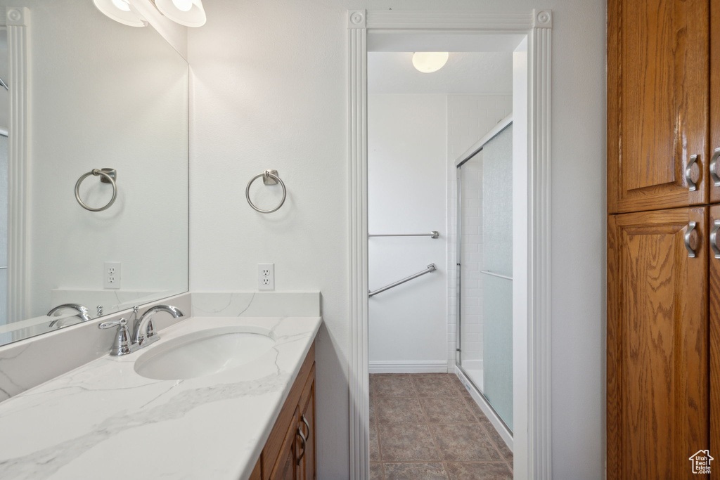 Bathroom featuring vanity and a stall shower