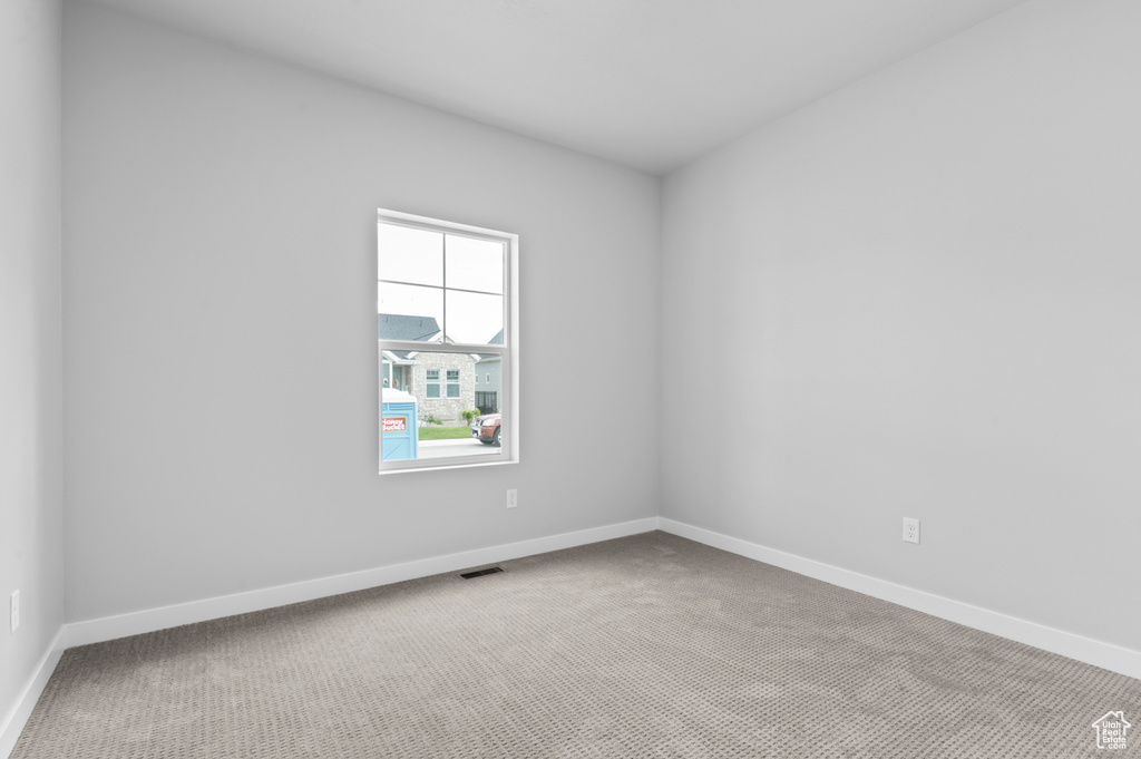 Unfurnished room featuring carpet floors and baseboards