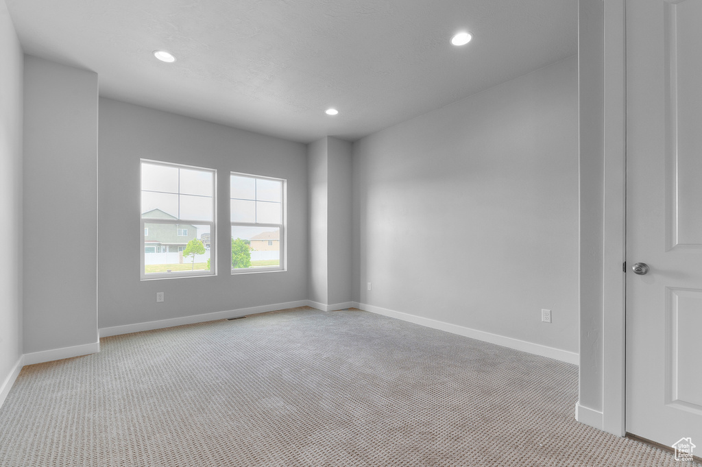 Unfurnished room with light carpet, recessed lighting, and baseboards