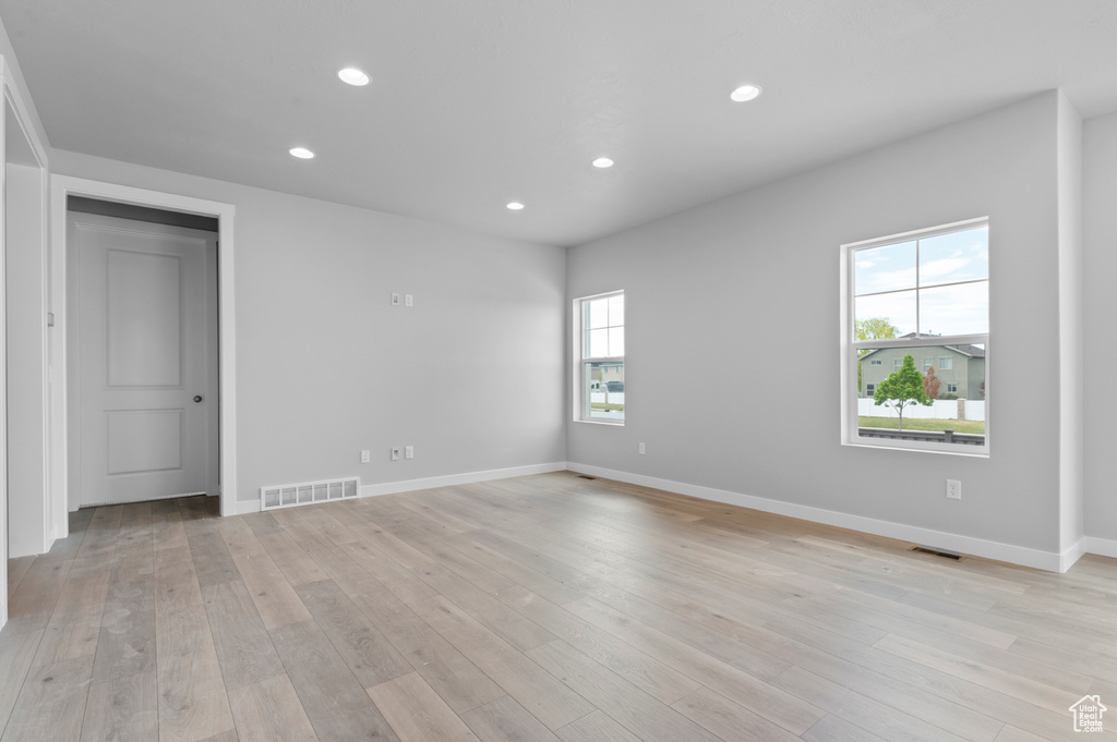 Unfurnished room featuring recessed lighting, light wood-style flooring, and baseboards