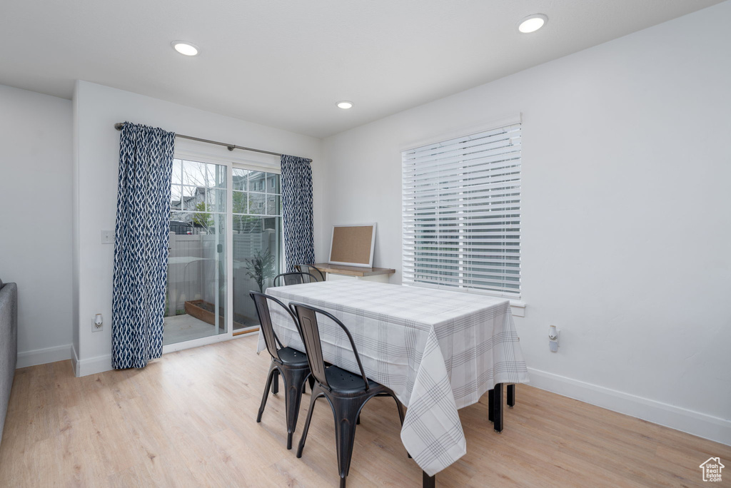 Dining room featuring baseboards, recessed lighting, and light wood finished floors