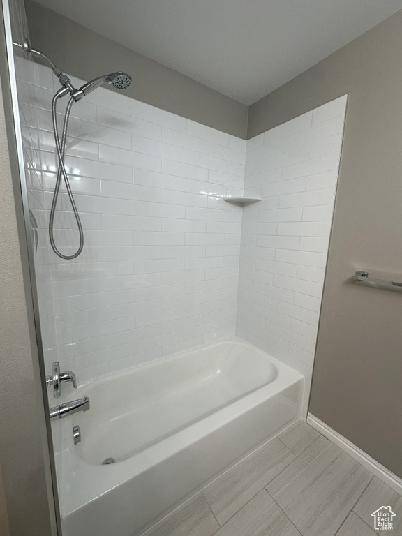 Full bath with baseboards and bathtub / shower combination