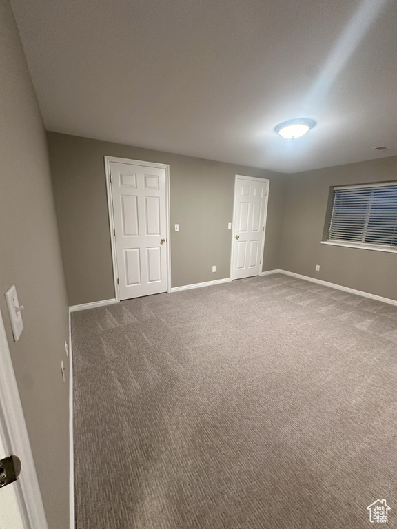 Spare room with baseboards and carpet floors