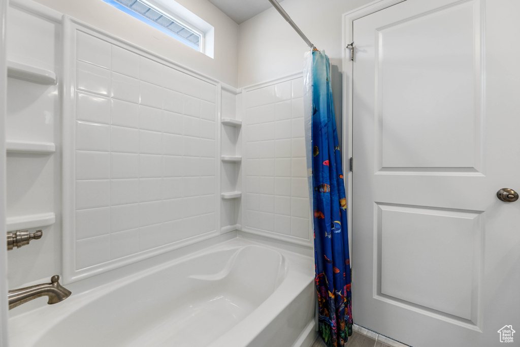 Full bath featuring shower / bath combo with shower curtain