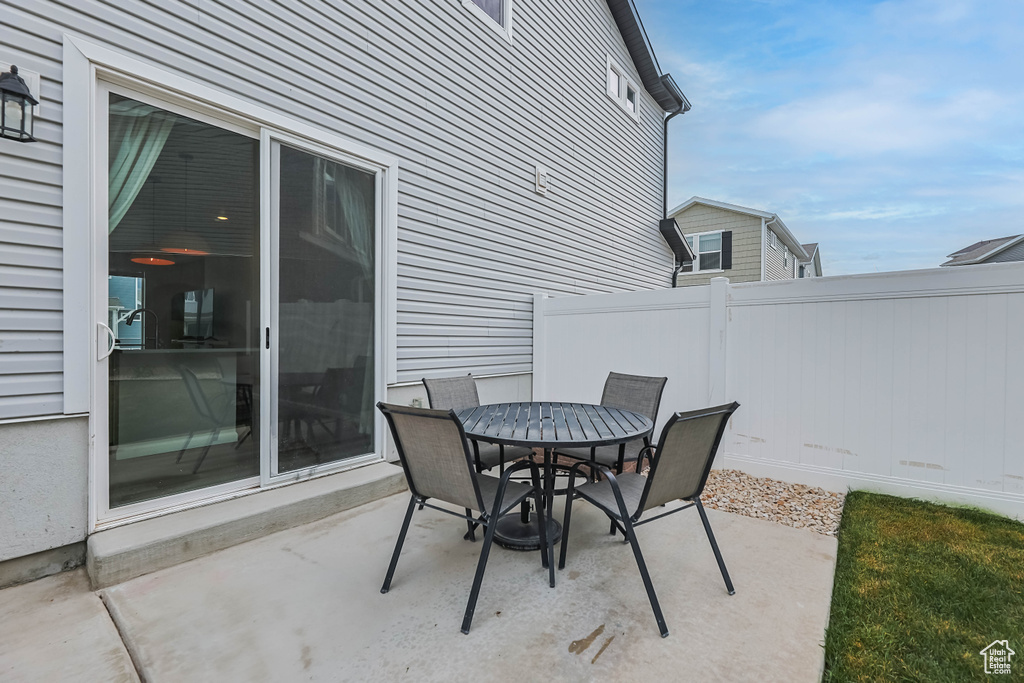 View of patio featuring fence and outdoor dining space