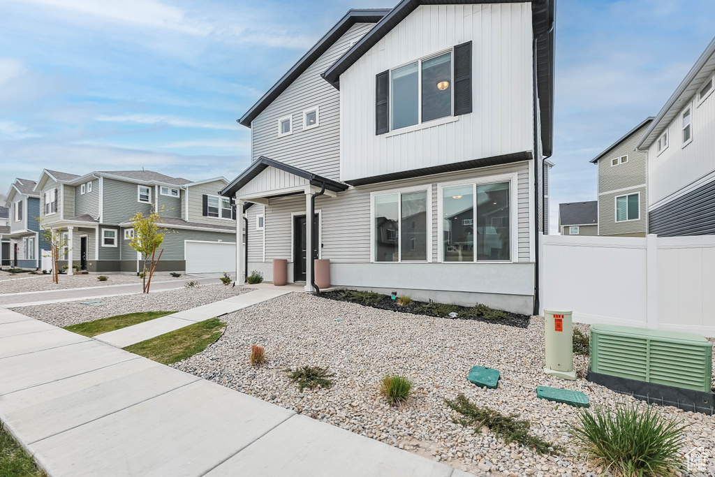 View of front of home with fence and a residential view