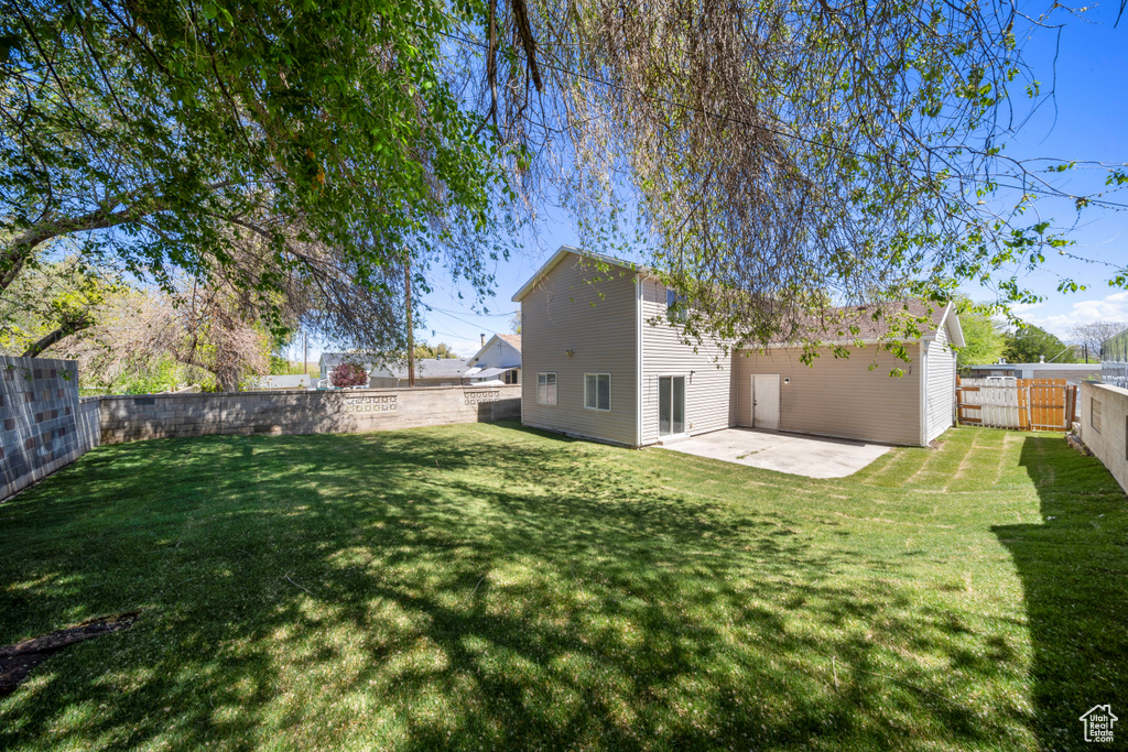 View of yard featuring a patio and a fenced backyard