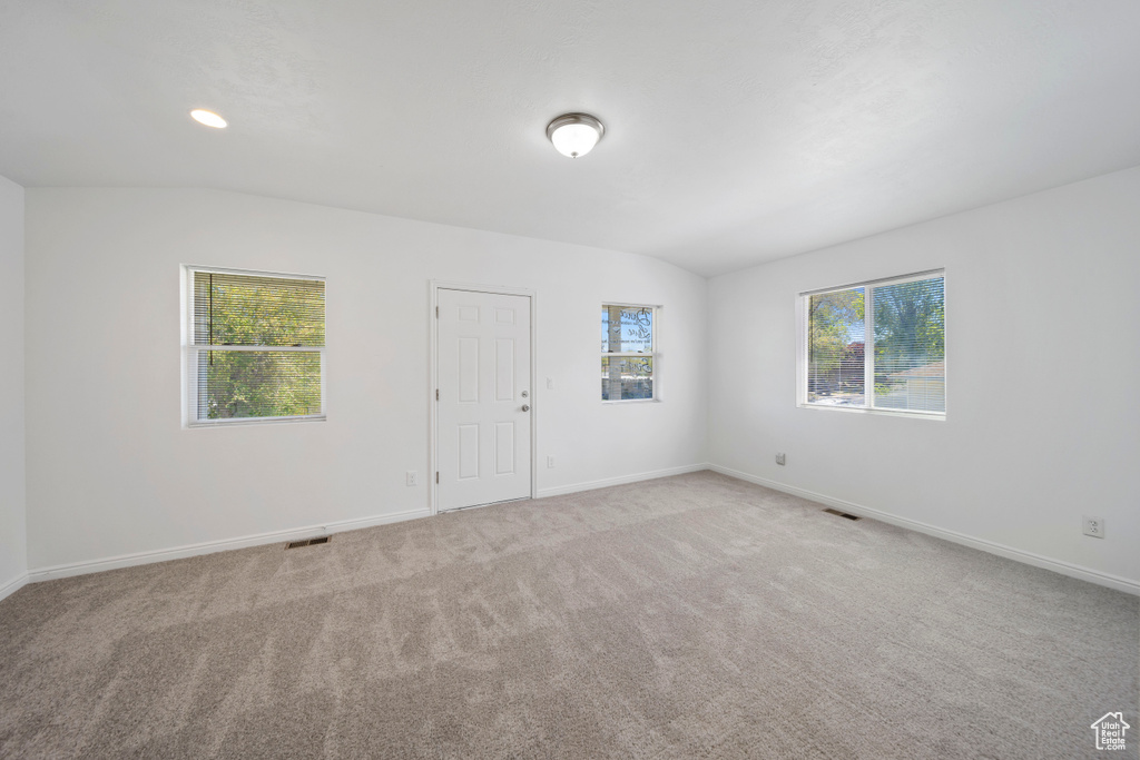 Empty room with carpet flooring and baseboards
