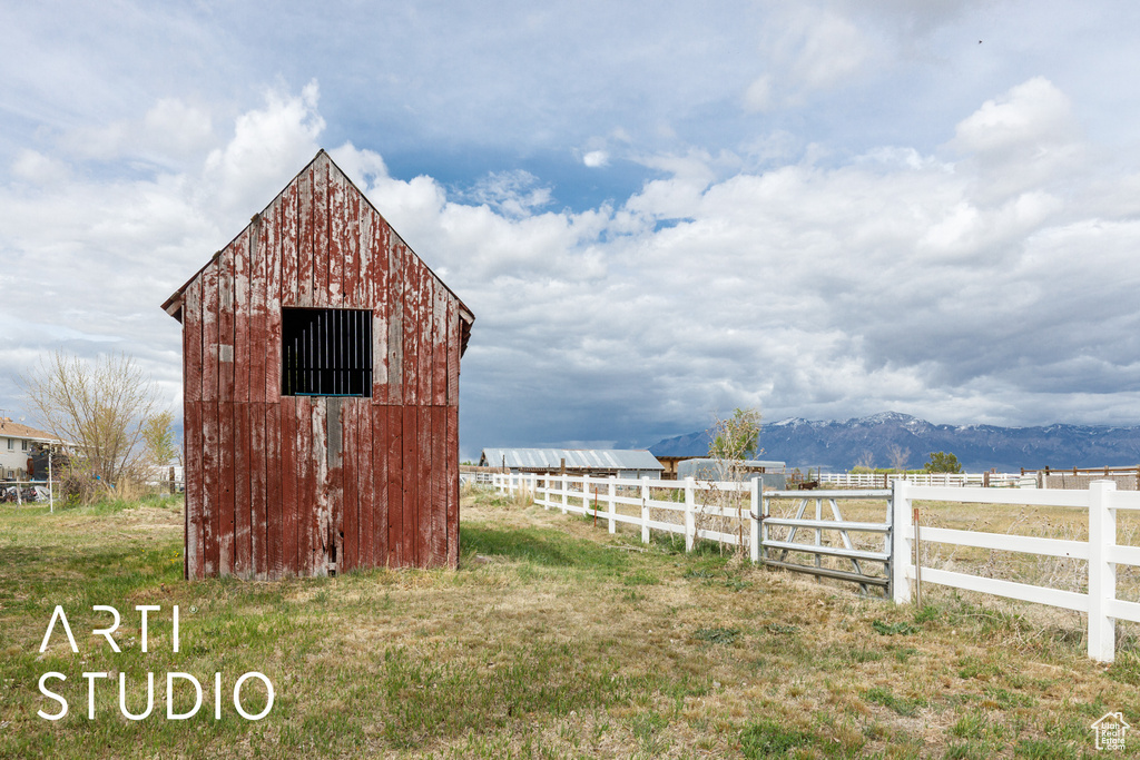 View of outdoor structure featuring fence and an outbuilding