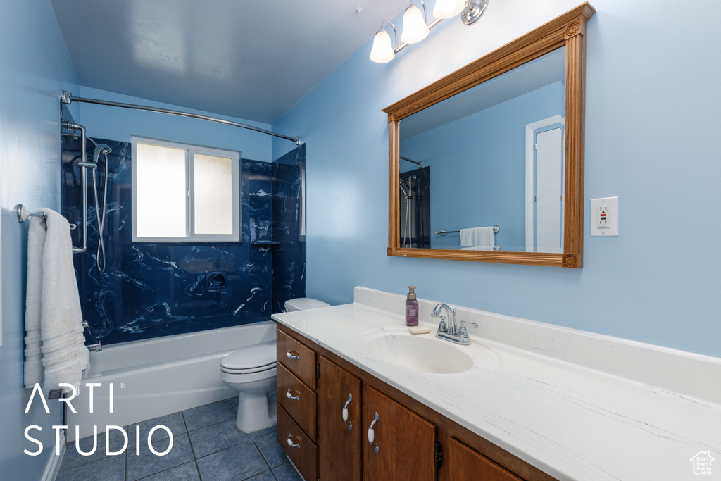 Bathroom featuring toilet, shower / bathing tub combination, tile patterned flooring, and vanity