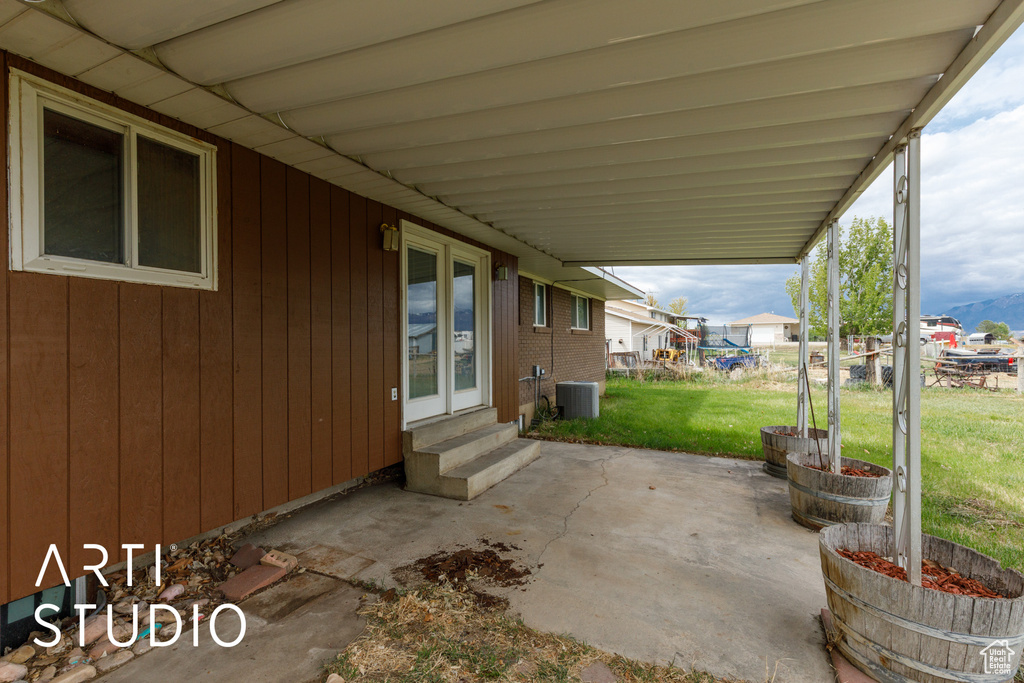 View of patio / terrace featuring entry steps and central AC unit