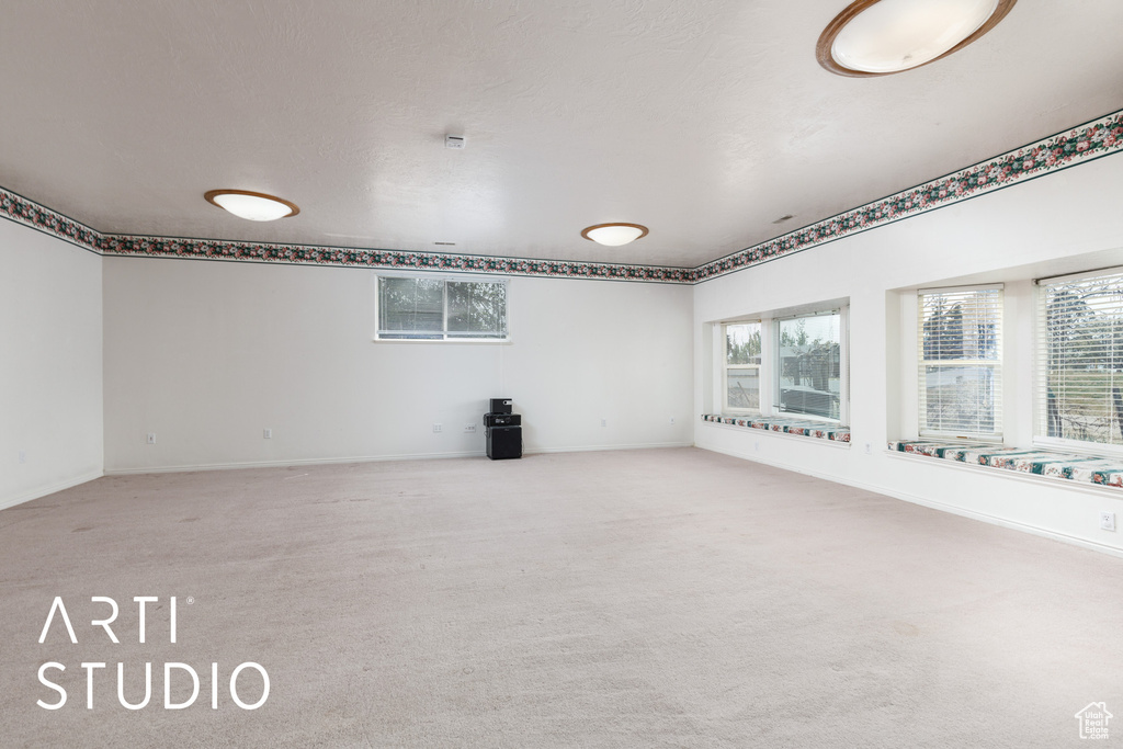 Carpeted empty room with baseboards