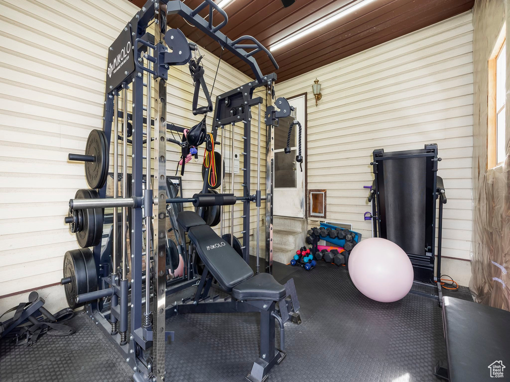 Workout room featuring wooden walls