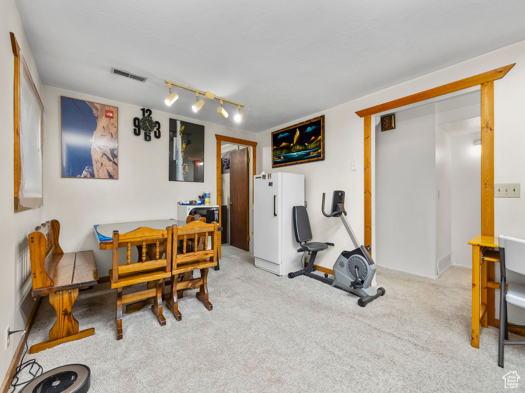 Dining room featuring visible vents, carpet flooring, and baseboards