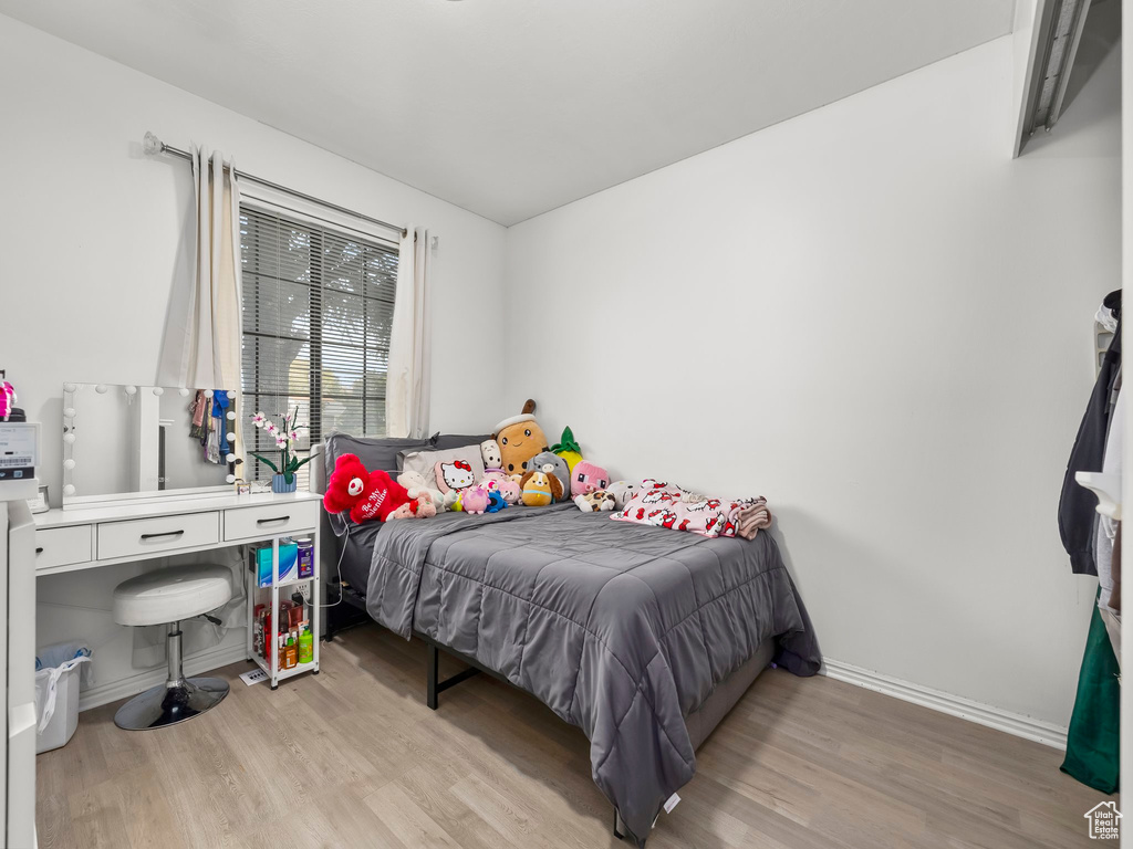 Bedroom with baseboards and wood finished floors
