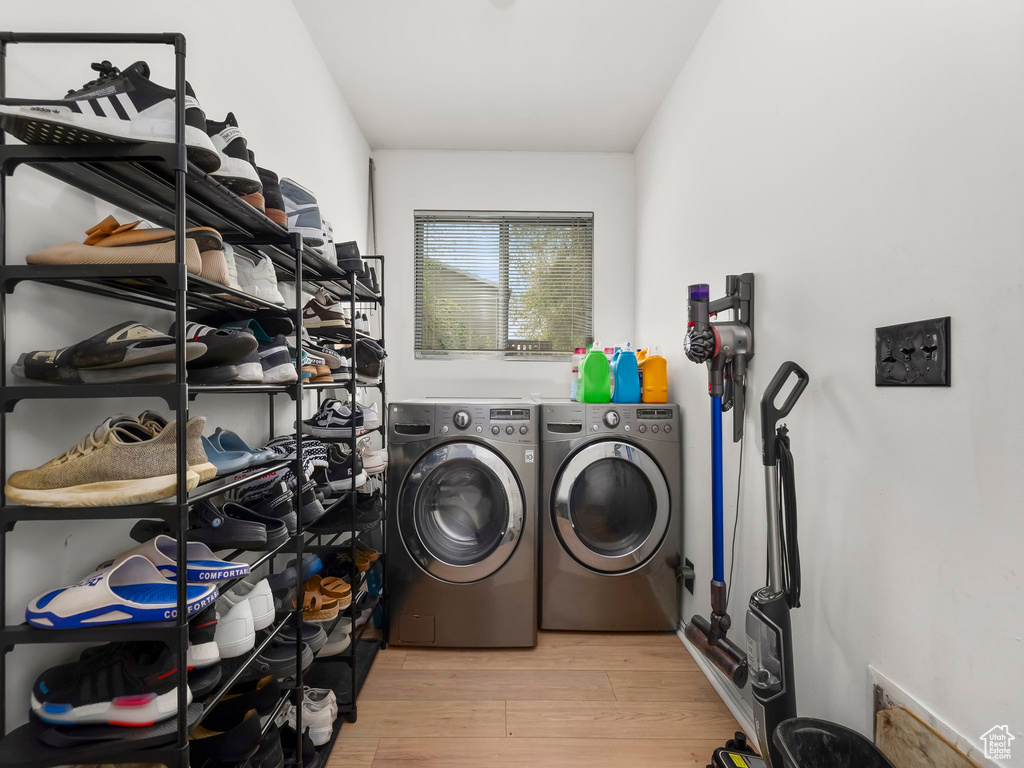 Clothes washing area featuring laundry area, light wood-style flooring, and independent washer and dryer