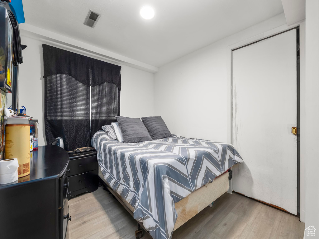 Bedroom with visible vents and light wood-style flooring