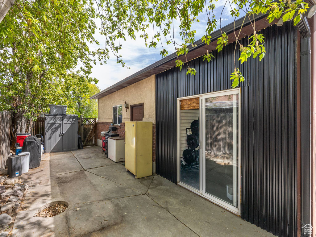 View of home's exterior featuring fence and a patio area