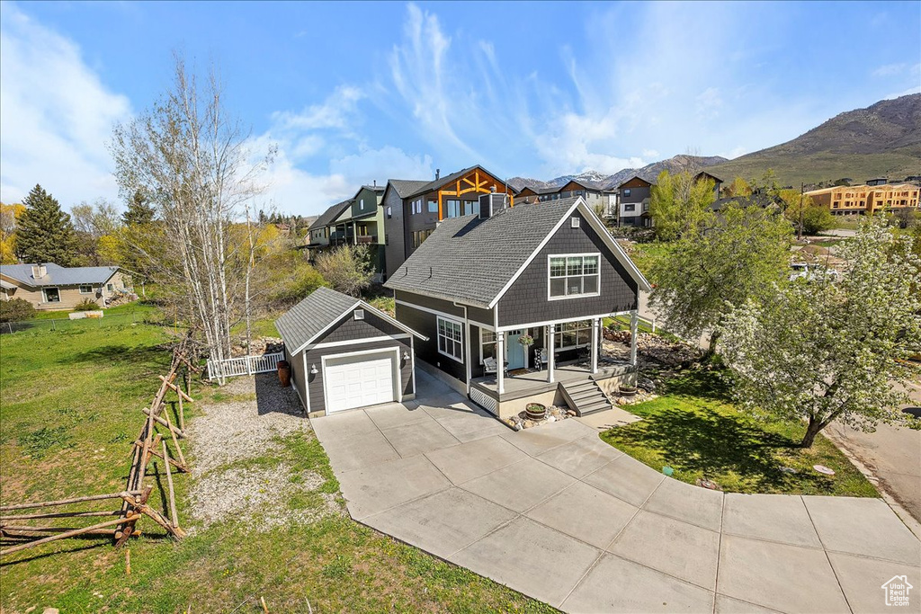View of front of house featuring fence, a front yard, concrete driveway, a porch, and a residential view
