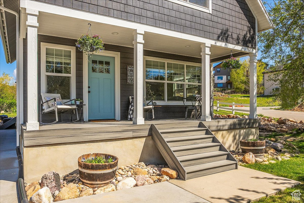 Doorway to property with covered porch