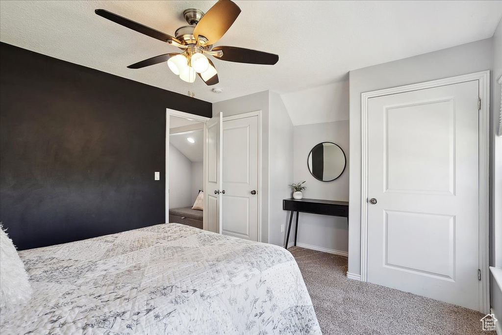 Carpeted bedroom featuring baseboards and ceiling fan