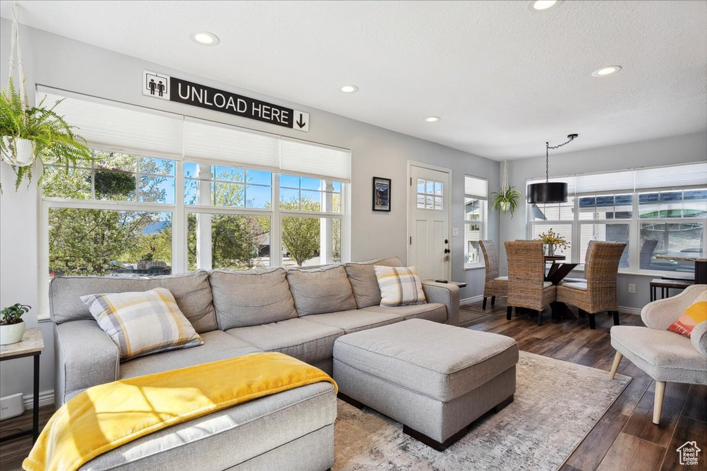 Living area with recessed lighting, baseboards, and wood finished floors